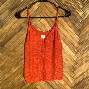 Women’s size: small red cheetah print blouse.